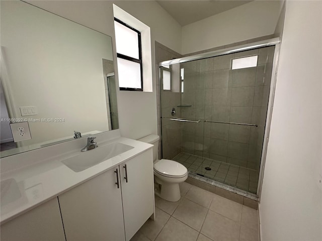 bathroom with walk in shower, tile patterned flooring, vanity, and toilet