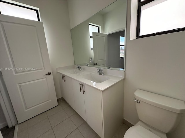 bathroom with vanity, toilet, and tile patterned floors