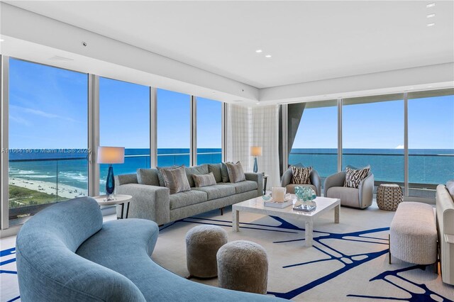 carpeted living room with a water view