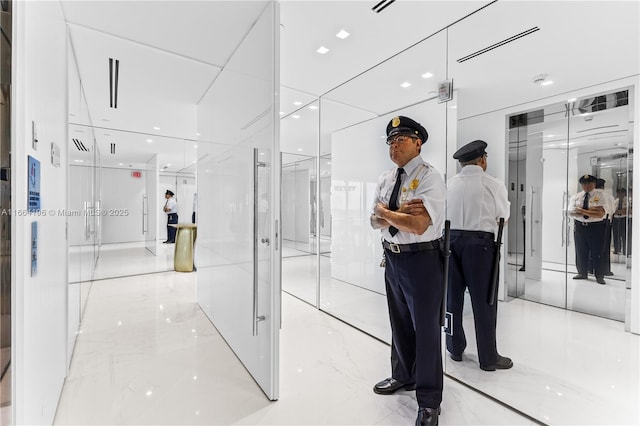 corridor with marble finish floor