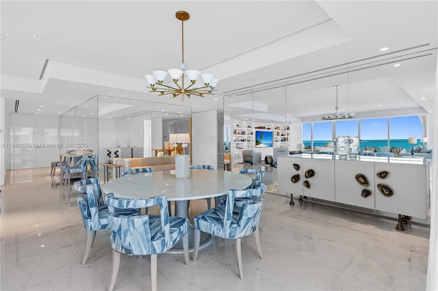 dining area with a chandelier, marble finish floor, and recessed lighting