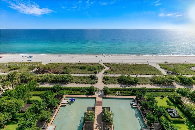 aerial view featuring a water view and a beach view