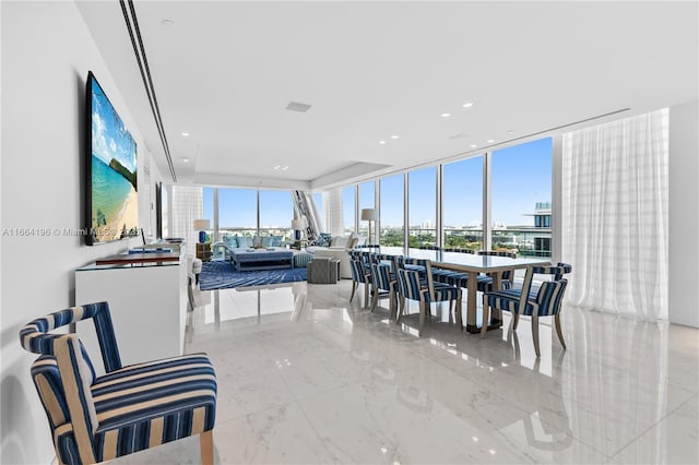 dining room featuring marble finish floor and floor to ceiling windows