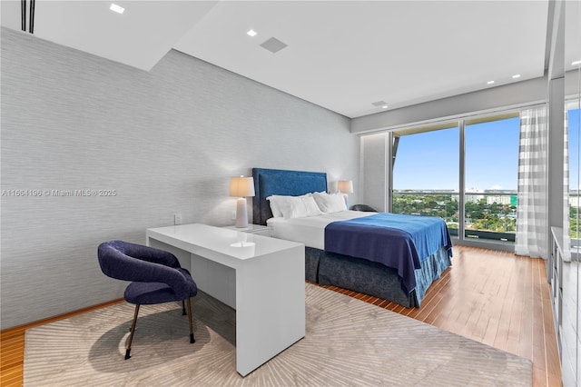 bedroom with recessed lighting and hardwood / wood-style floors
