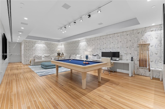 playroom with hardwood / wood-style flooring, pool table, and a tray ceiling