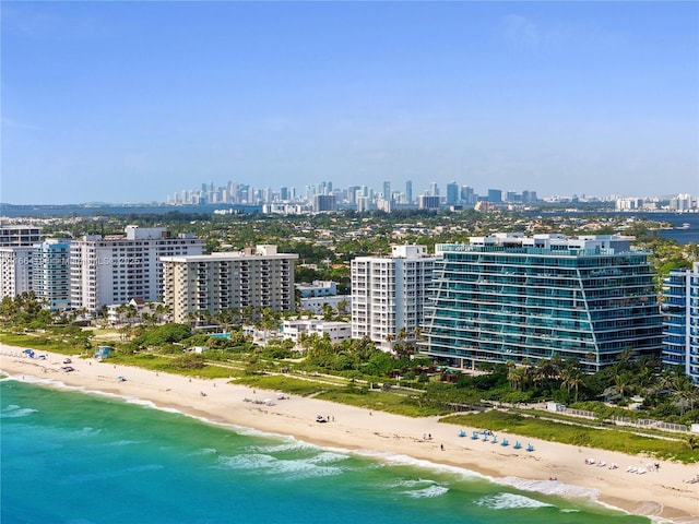 bird's eye view featuring a water view and a beach view