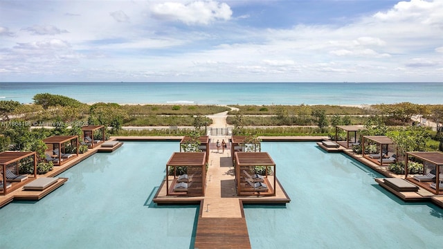 view of swimming pool featuring a pergola and a water view