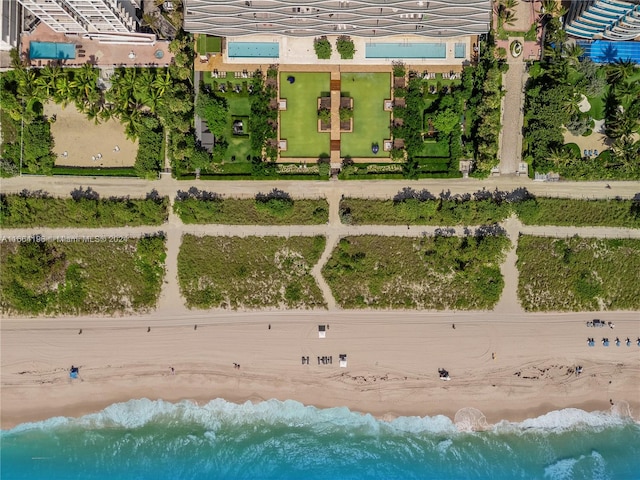 aerial view with a water view and a beach view