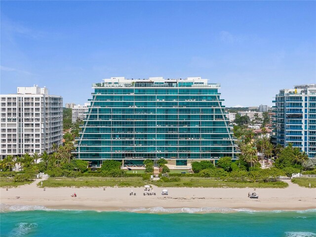 view of property featuring a water view and a beach view