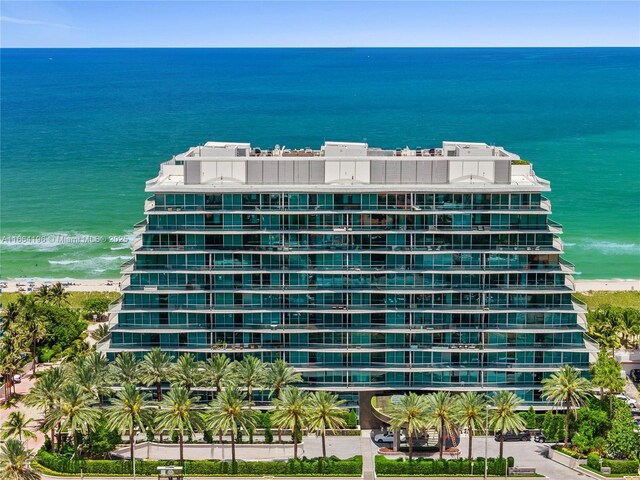 view of property featuring a view of the beach and a water view