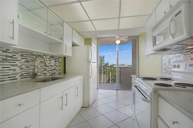 kitchen with white cabinets, tasteful backsplash, a paneled ceiling, sink, and white appliances