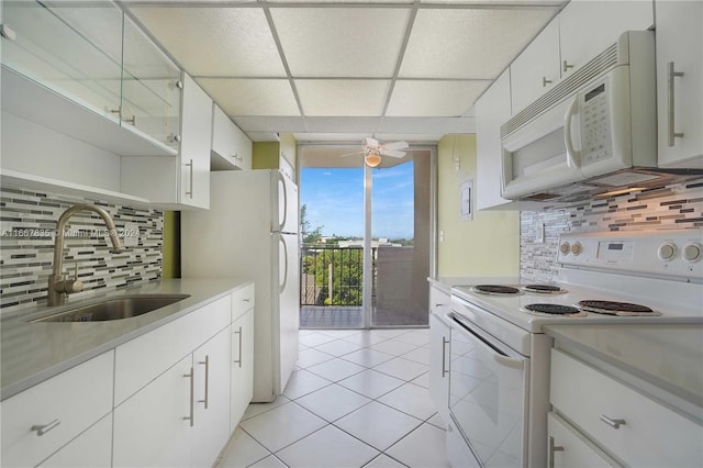 kitchen with white cabinetry, tasteful backsplash, sink, and white appliances