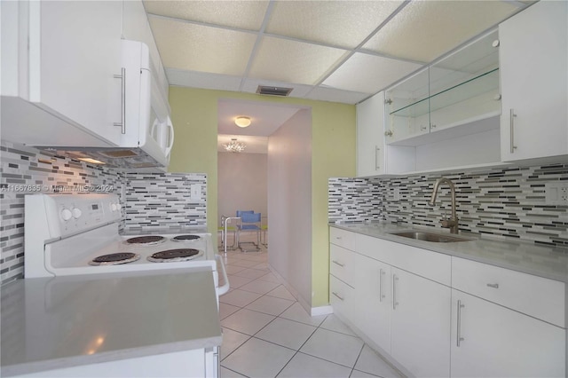 kitchen featuring sink, white cabinets, white appliances, and backsplash