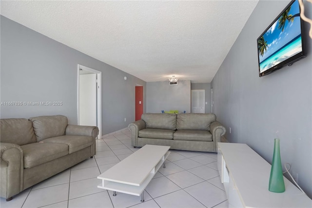 7921 Byron Ave Unit 507, Miami Beach, FL 33141 - living area featuring a textured ceiling and light tile patterned flooring