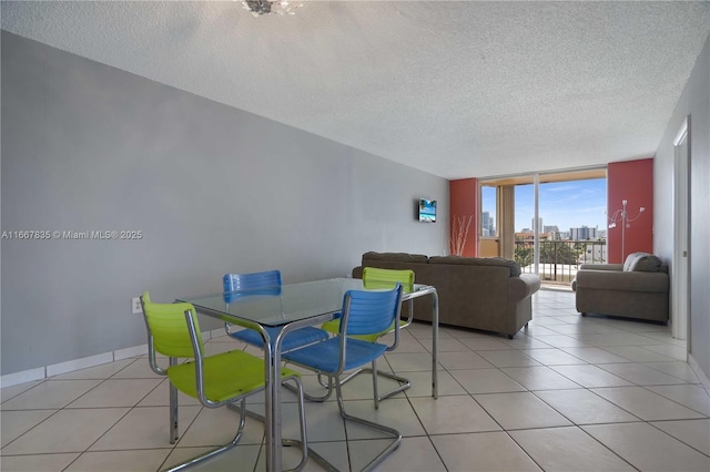 7921 Byron Ave Unit 507, Miami Beach, FL 33141 - dining area featuring light tile patterned floors, baseboards, and a textured ceiling