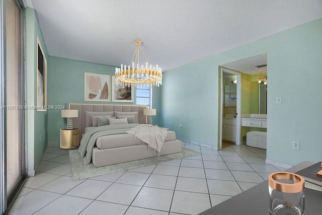 tiled bedroom featuring a notable chandelier, a textured ceiling, and ensuite bath