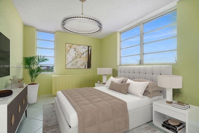 tiled bedroom with a textured ceiling and radiator heating unit