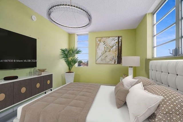 bedroom featuring a textured ceiling and multiple windows