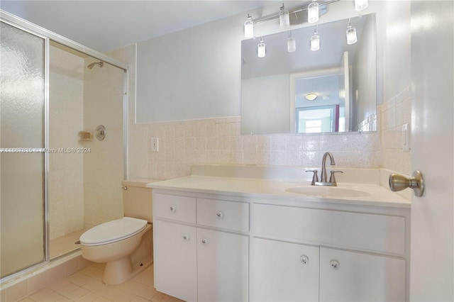 bathroom with walk in shower, tile walls, toilet, vanity, and tile patterned floors