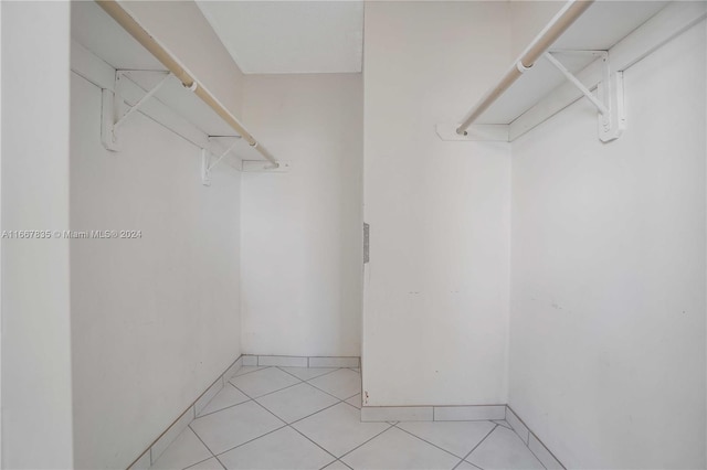 spacious closet featuring light tile patterned flooring