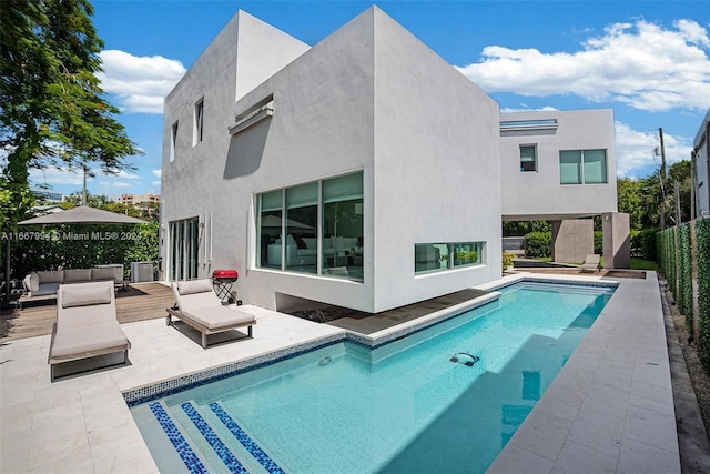 view of swimming pool with an outdoor living space and a patio