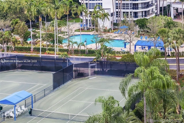 view of sport court with a community pool