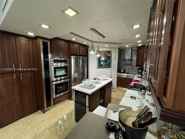 kitchen featuring appliances with stainless steel finishes, backsplash, wall chimney exhaust hood, pendant lighting, and a center island