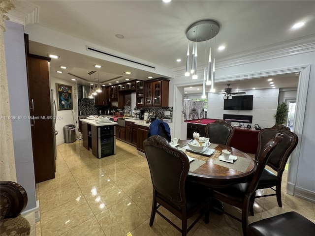 dining room with ceiling fan and crown molding