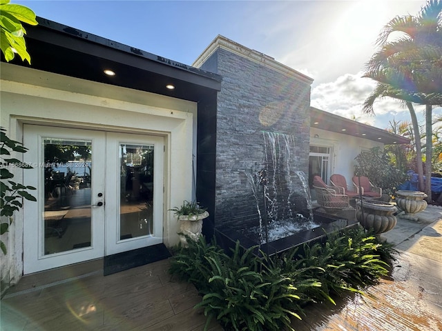 property entrance with a patio area and french doors