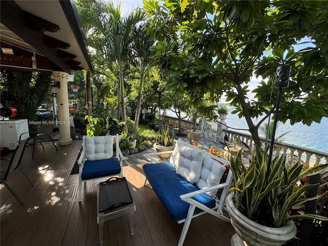 deck with a water view and an outdoor living space