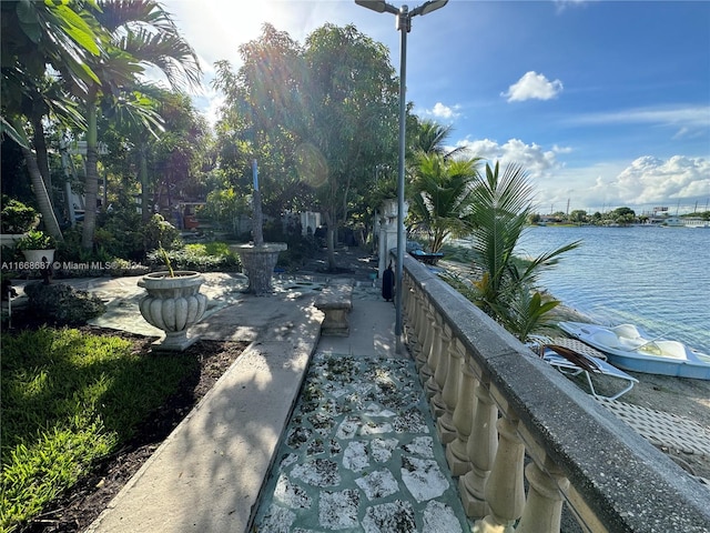 exterior space with a water view and a patio area