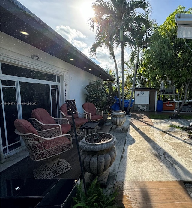 view of patio / terrace with a shed and an outdoor fire pit