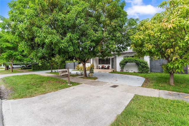 view of property hidden behind natural elements featuring a front yard