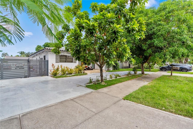 view of front of home featuring a garage and a front lawn