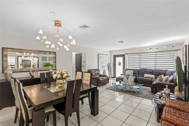 dining space featuring light tile patterned flooring and a chandelier