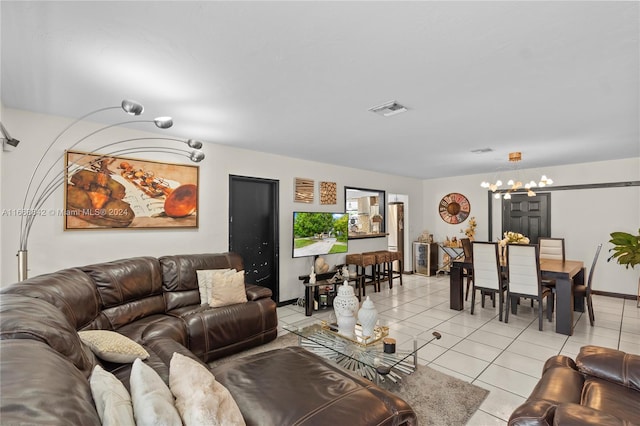 tiled living room with a notable chandelier