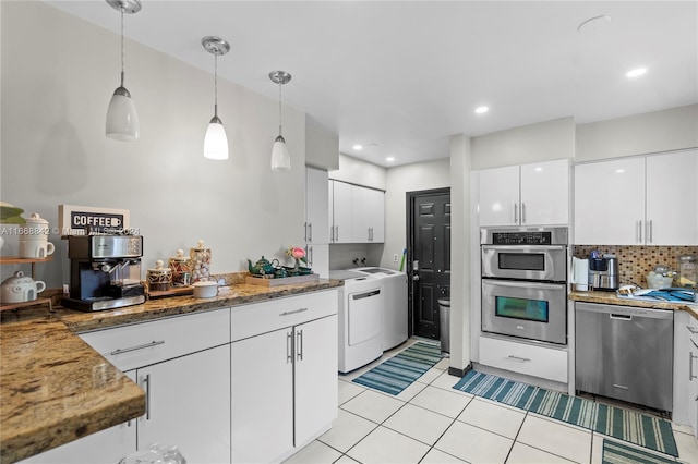 kitchen featuring pendant lighting, washer / clothes dryer, light tile patterned flooring, white cabinetry, and appliances with stainless steel finishes