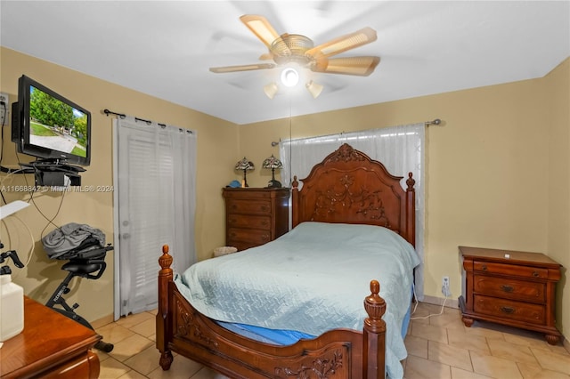 tiled bedroom featuring ceiling fan