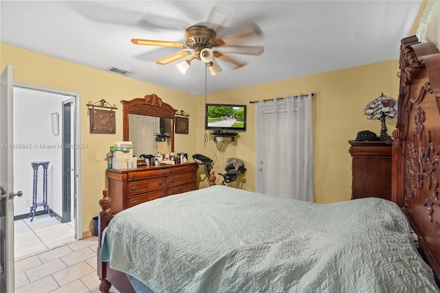 tiled bedroom featuring ceiling fan