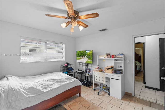 bedroom featuring light tile patterned floors and ceiling fan