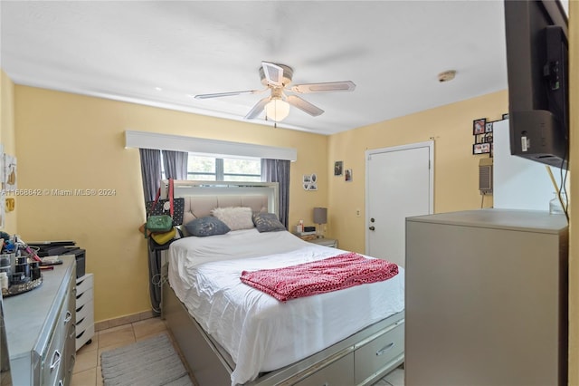 bedroom with ceiling fan and light tile patterned floors