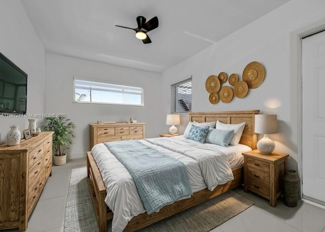 bedroom with ceiling fan and tile patterned floors