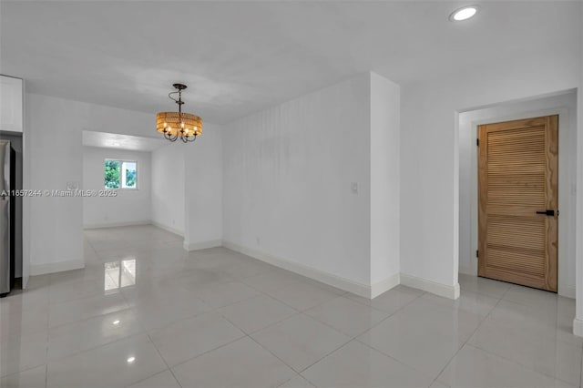 unfurnished room with recessed lighting, baseboards, a chandelier, and light tile patterned flooring