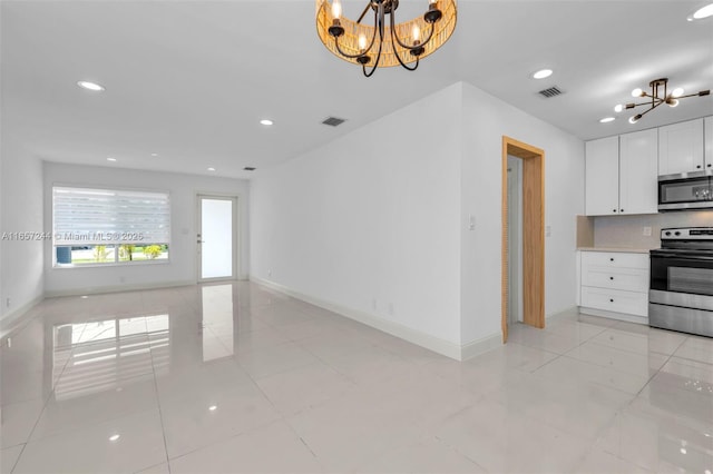 kitchen with an inviting chandelier, visible vents, and stainless steel appliances