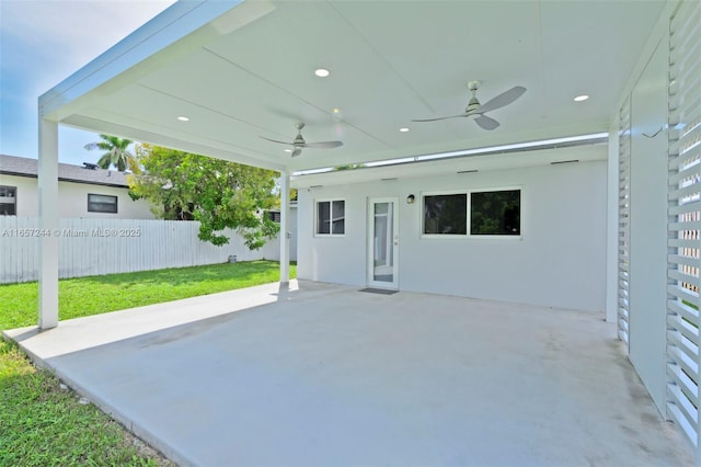 view of patio with ceiling fan and fence