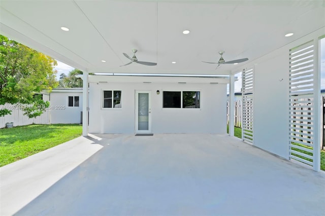 view of patio with ceiling fan and fence