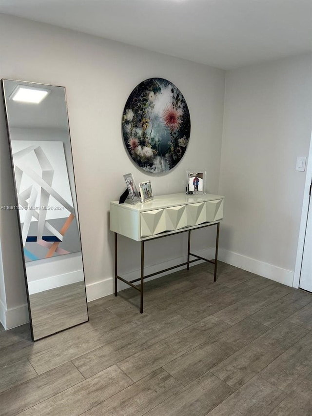 office space featuring baseboards and wood finished floors