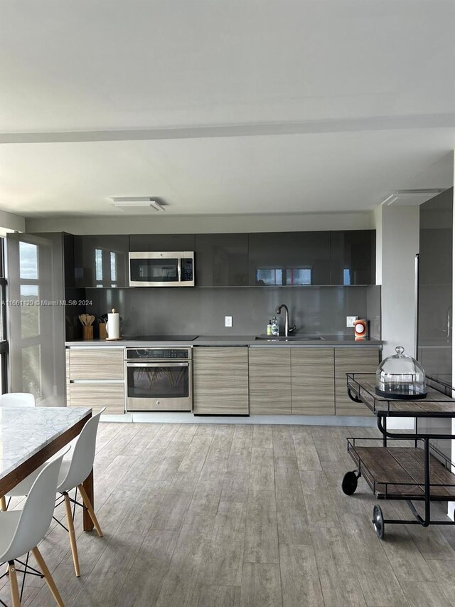 kitchen featuring sink, stainless steel appliances, and light hardwood / wood-style floors