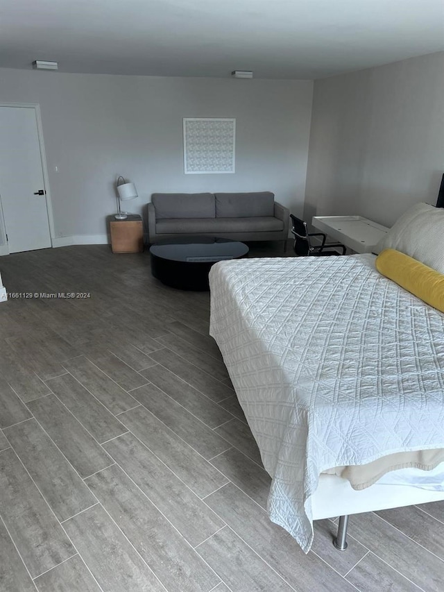 bedroom with hardwood / wood-style floors