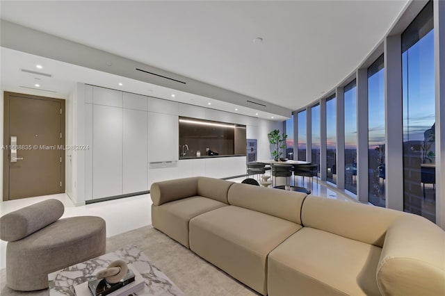living room featuring recessed lighting and floor to ceiling windows